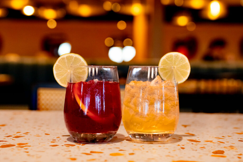 two cocktails one red and orange
